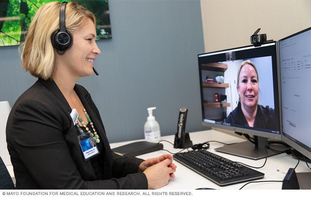 A person talks with a member of the health care team by way of a video visit.