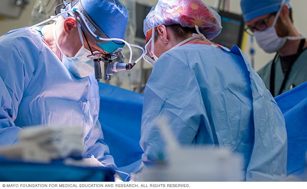 A surgeon and surgical team during surgery.