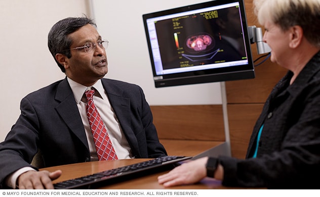 A pancreatic cancer specialist (oncologist) explaining a diagnostic image to a patient