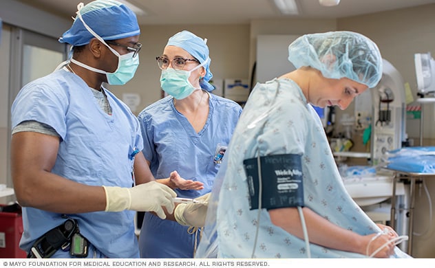 Anesthesiology specialists consult for a patient epidural.