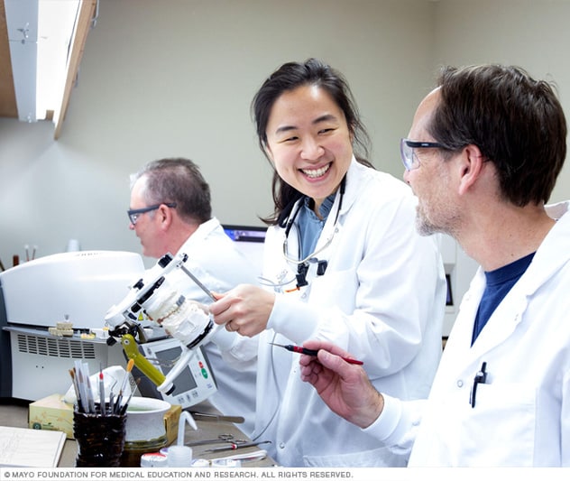 A dentist specializing in prosthodontics works with a dental lab technician.